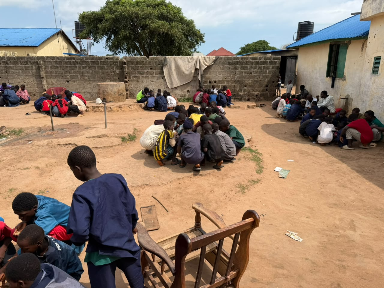 Daara students gathered in the courtyard to share a communal meal